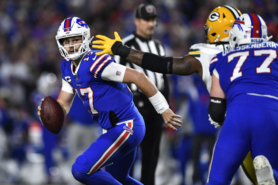 Buffalo Bills quarterback Josh Allen (17) runs away from Green Bay Packers linebacker Rashan Gary (52) during the first half of an NFL football game Sunday, Oct. 30, 2022, in Orchard Park. (AP Photo/Adrian Kraus)