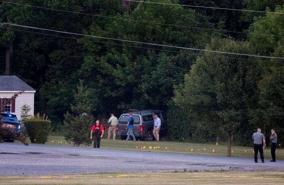Authorities gather at the scene of a shootout between Pennsylvania state troopers and a gunman near Mifflintown on Saturday.