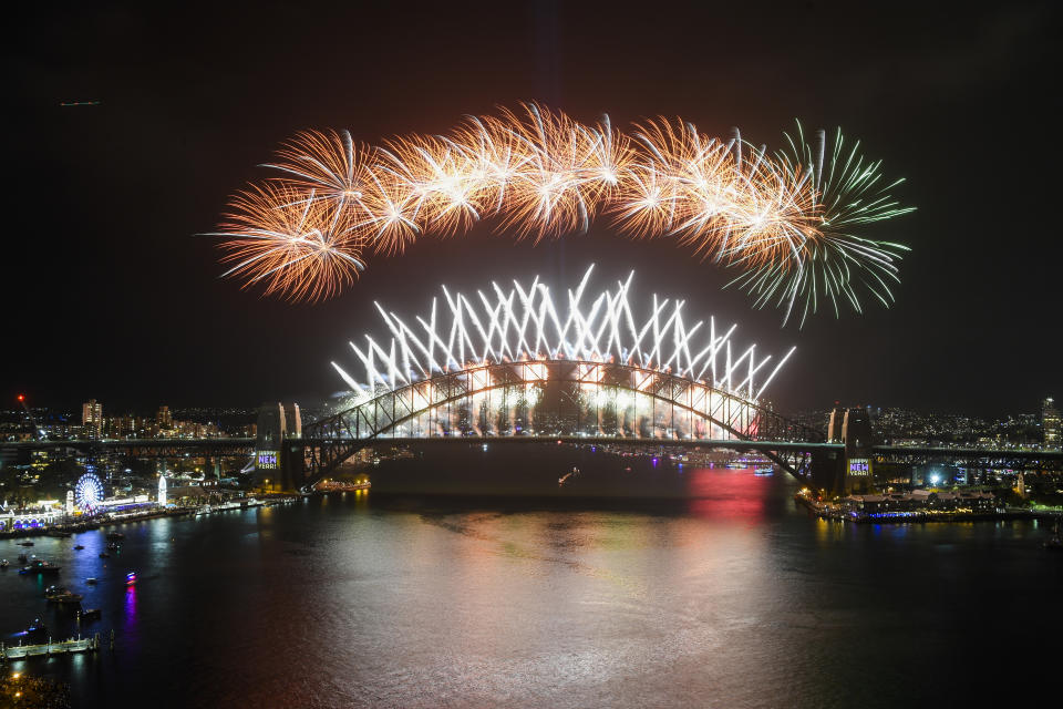 Midnight fireworks explode over the Sydney Harbour Bridge during New Year's eve celebrations in Sydney, Tuesday, Dec.31, 2019. (Lukas Coch/AAP Images via AP)