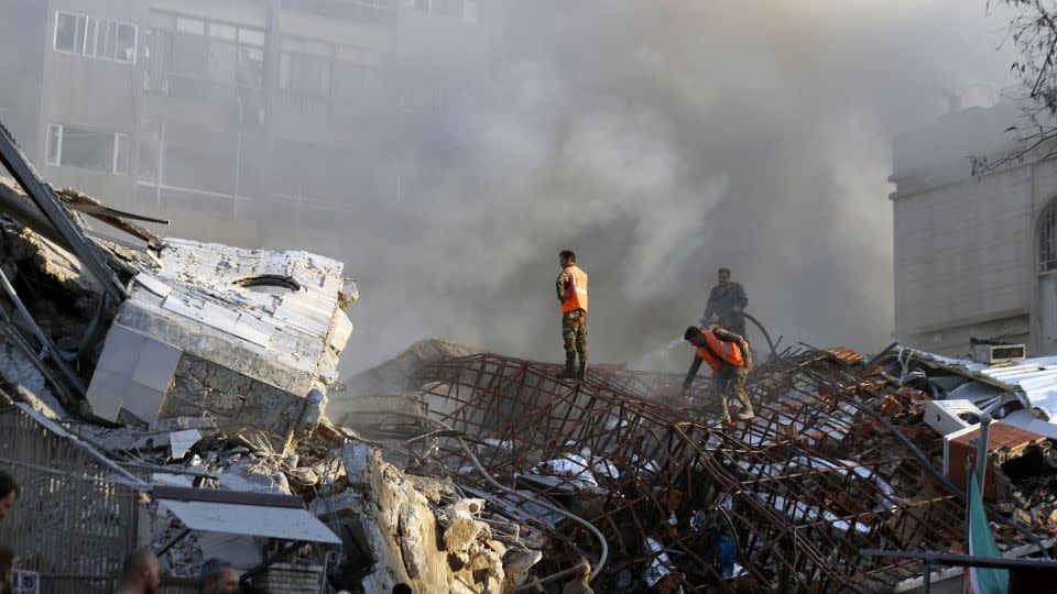 Emergency services work at a destroyed building hit by an air strike in Damascus, Syria, on April 1, 2024. - Omar Sanadiki/AP