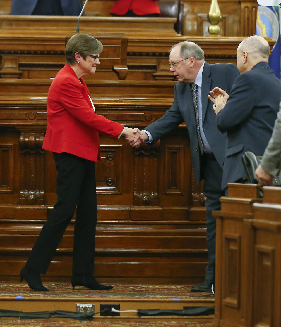 Kansas Gov. Laura Kelly, left, greets Senate Minority Leader Anthony Hensley after giving her first State of the State address to lawmakers on the floor of the Kansas House on Wednesday, Jan. 16, 2019, in Topeka, Kan. (Chris Neal/The Topeka Capital-Journal via AP)
