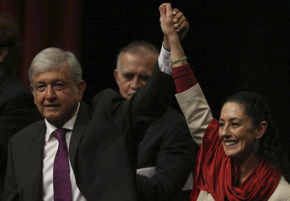 Presidential hopeful Andres Manuel Lopez Obrador, left, and Claudia Sheinbaum, coordinator of the Morena political party, hold hands at an event at the National Auditorium in Mexico City, Monday, Nov. 20, 2017. Lopez Obrador, making his third bid for Mexico’s presidency, laid out his platform for next year’s presidential elections. (AP Photo/Marco Ugarte)