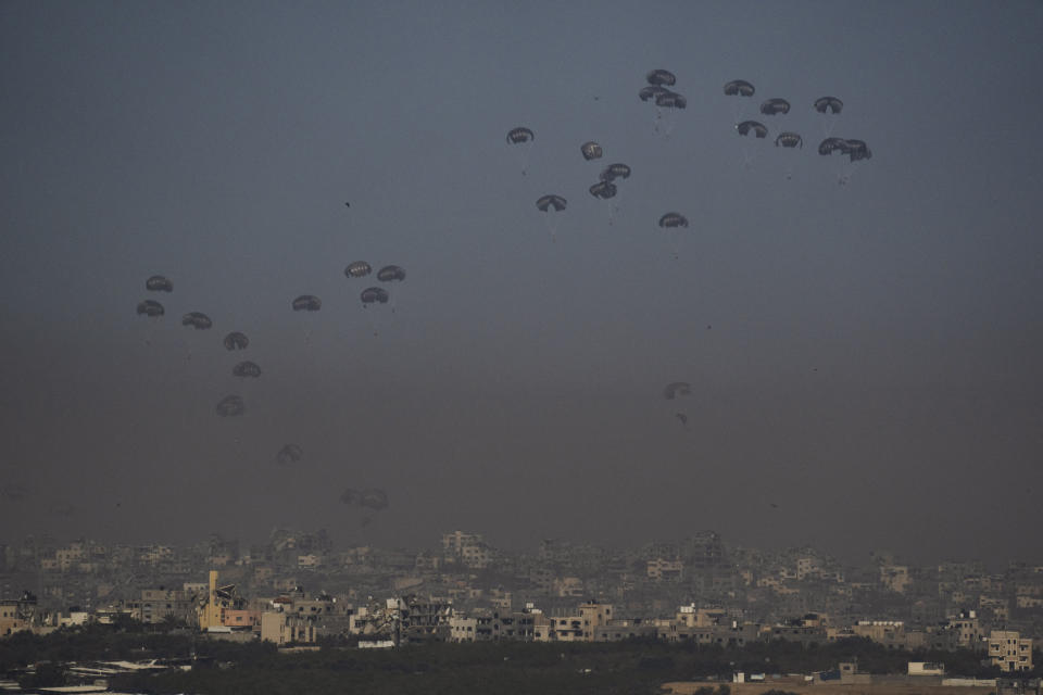 Parachutes drop supplies into the northern Gaza Strip as seen from southern Israel, Thursday, March 28, 2024. (AP Photo/Leo Correa)