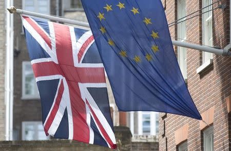 The Union Flag flies next to the European Flag outside the European Commission building in central London May 25, 2014. REUTERS/Neil Hall