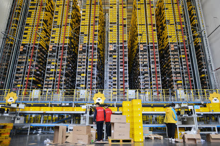 Employees work at a logistics base of Suning ahead of the Singles Day online shopping festival in Nanjing, Jiangsu province, China November 8, 2018. Picture taken November 8, 2018. REUTERS/Stringer