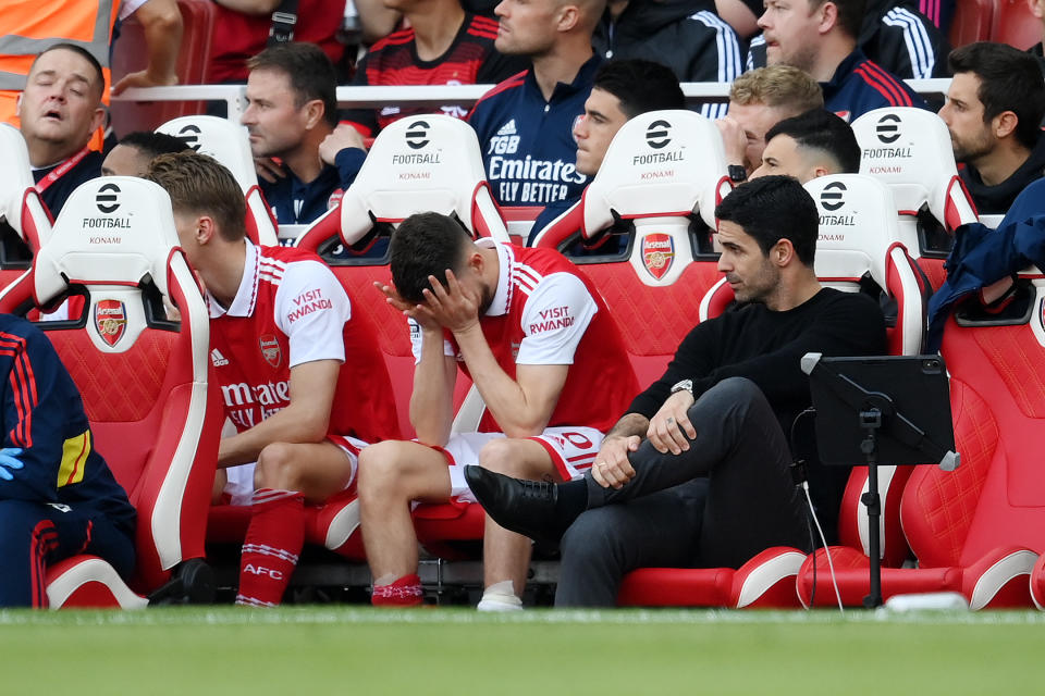 Arsenal manager Mikel Arteta (right) looks on with dejected Arsenal substitutes during their defeat by Brighton. 