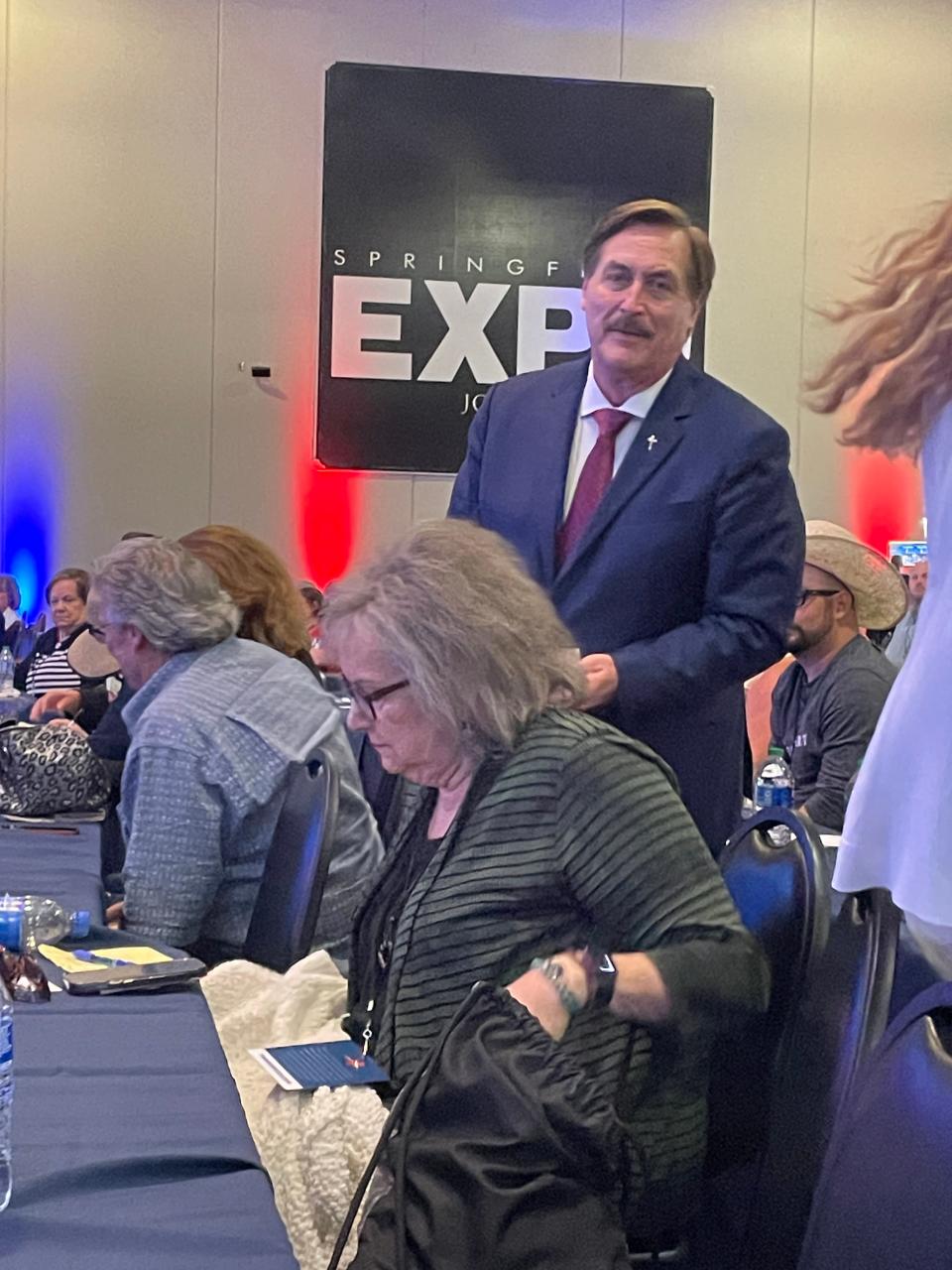 Mike Lindell walks among the crowd and collects donation checks from attendees at the Election Crime Bureau Summit on Aug. 17, 2023 in Springfield, MO.