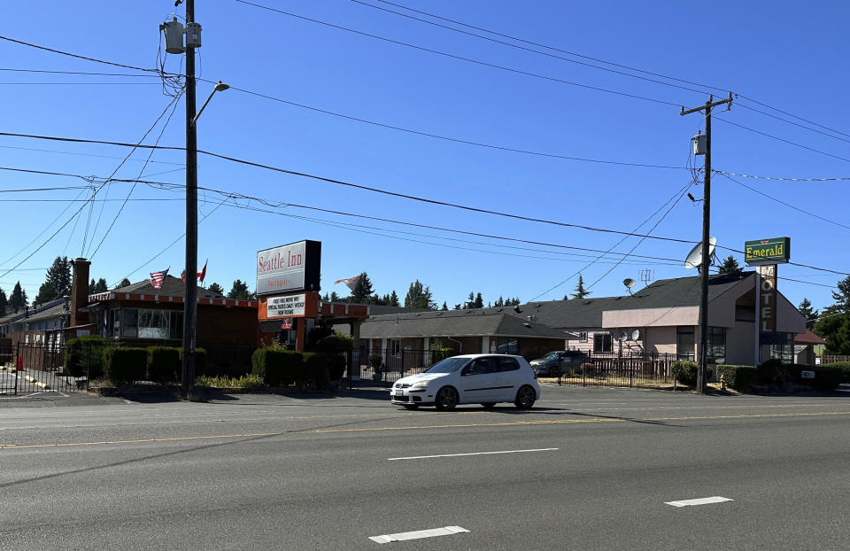 A car drives by the Emerald Motel and Seattle Inn on Aurora Avenue North in Seattle, on Thursday, Aug. 3, 2023. Police recently declared the establishments to be chronic nuisances due to rampant prostitution and other criminal activity, a step that requires the owners to demonstrate how they will prevent their properties from being used for criminal behavior. The recent harrowing escape of a woman who was abducted after engaging in prostitution on Seattle has helped focus attention on the consequences of tolerating an open sex trade along the thoroughfare. (AP Photo/Gene Johnson)