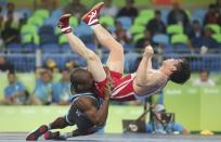 <p>Yang Kyong Il (PRK) of North Korea and Yowlys Bonne Rodriguez (CUB) of Cuba compete. (Reuters) </p>