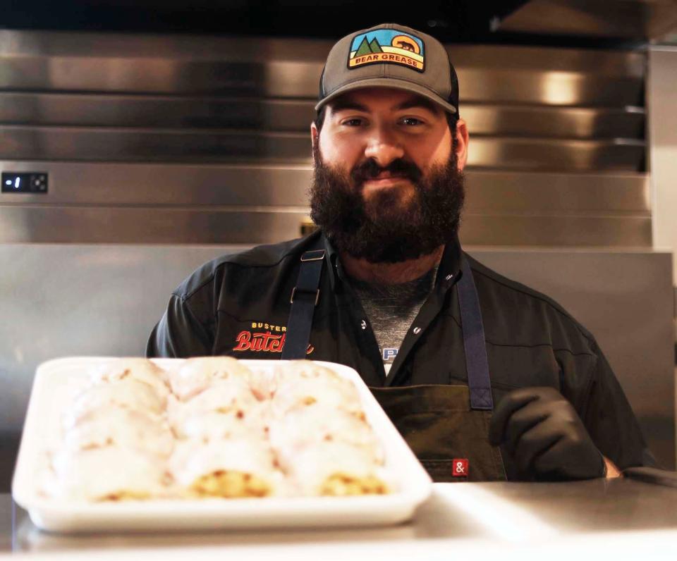 Butcher Mitchell Marable prepares to wrap up some boudin-stuffed quail inside the newly opened Buster’s Butcher, at 199 S. Highland St. in Memphis, Tenn., on Aug. 18, 2023.