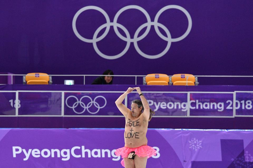 <p>A shirtless man clad in a tutu dances on the rink following the men’s 1,000m speed skating event medal ceremony during the Pyeongchang 2018 Winter Olympic Games at the Gangneung Oval in Gangneung on February 23, 2018. / AFP PHOTO / Mladen ANTONOV </p>