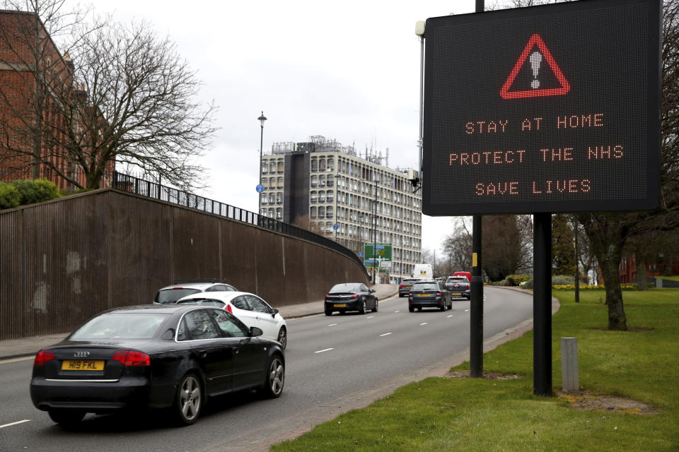 A 'Stay at Home, Protect the NHS, Save Lives' message is displayed to motorists on the ring road in Wolverhampton, England, Saturday, March 28, 2020. The new coronavirus causes mild or moderate symptoms for most people, but for some, especially older adults and people with existing health problems, it can cause more severe illness or death. (Nick Potts/PA via AP)