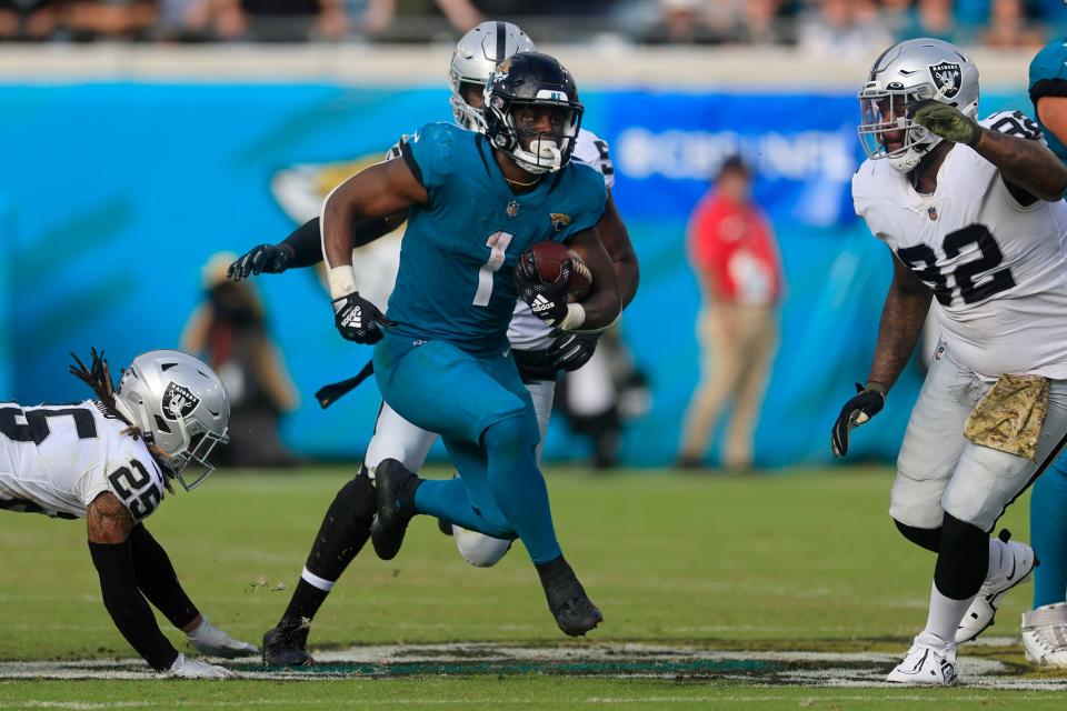 Jacksonville Jaguars running back Travis Etienne Jr. (1) rushes for yards during the fourth quarter of a regular season NFL football matchup Sunday, Nov. 6, 2022 at TIAA Bank Field in Jacksonville. The Jacksonville Jaguars held off the Las Vegas Raiders 27-20. [Corey Perrine/Florida Times-Union]