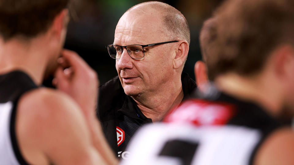 Port Adelaide coach Ken Hinkley is pictured in a team huddle.