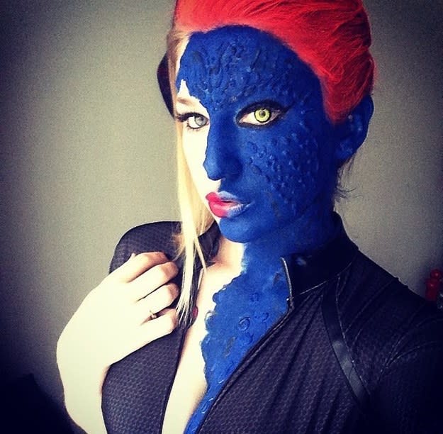 Half of someone's face covered in blue-changing makeup, mid-Mystique transformation
