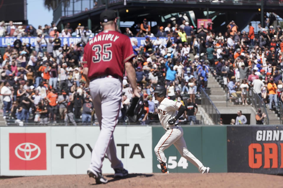San Francisco Giants' Wilmer Flores, bottom, rounds the bases after hitting a home run off of Arizona Diamondbacks pitcher Joe Mantiply (35) during the eighth inning of a baseball game in San Francisco, Wednesday, July 13, 2022. (AP Photo/Jeff Chiu)