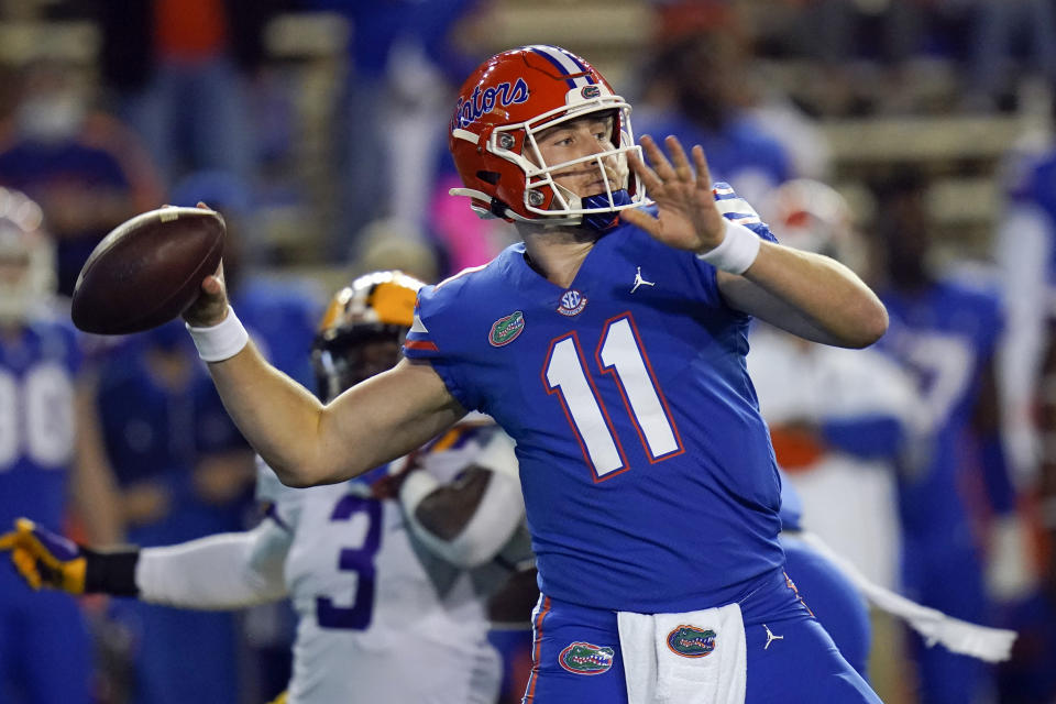 FILE - In this Dec. 12, 2020, file photo, Florida quarterback Kyle Trask (11) throws a pass against LSU during the first half of an NCAA college football game in Gainesville, Fla. Trask has been named a finalist for the Heisman Trophy. The Heisman will be awarded Jan. 5 during a virtual ceremony as the pandemic forced the cancellation of the usual trip to New York that for the presentation that usually comes with being a finalist. (AP Photo/John Raoux, File)