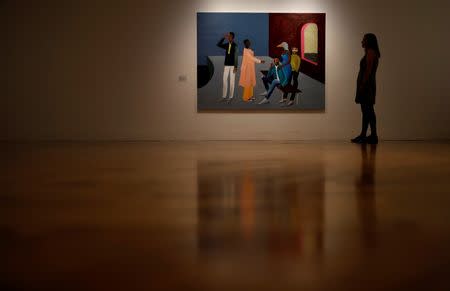 FILE PHOTO: A gallery worker stands next to a painting by Turner Prize nominee Lubaina Himid at the press preview for the 2017 Turner Prize at Ferens Art Gallery in Hull, Britain September 25, 2017. REUTERS/Phil Noble