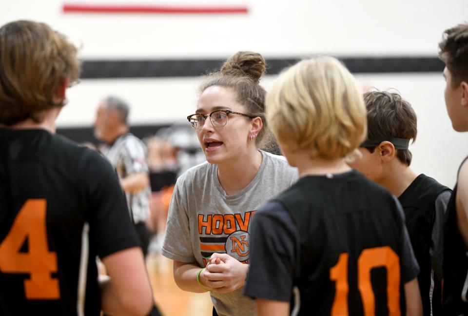 North Canton Middle School 7th grade coach Briana Kinsley works with her team during a game at Green Middle School. Wednesday, December 20, 2023.