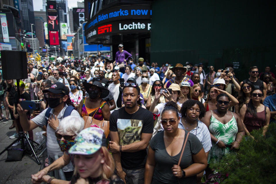 People try to see a free outdoor event organized by The Broadway League as celebrations take place during Juneteenth at Times Square on Saturday, June 19, 2021, in New York. Parades, picnics and lessons in history marked Juneteenth celebrations in the U.S., a day that marks the arrival of news to enslaved Black people in a Texas town that the Confederacy had surrendered in 1865 and they were free. (AP Photo/Eduardo Munoz Alvarez)