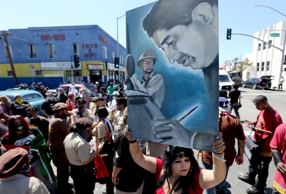 Hundreds of people march along Whittier Boulevard to Ruben Salazar Park.