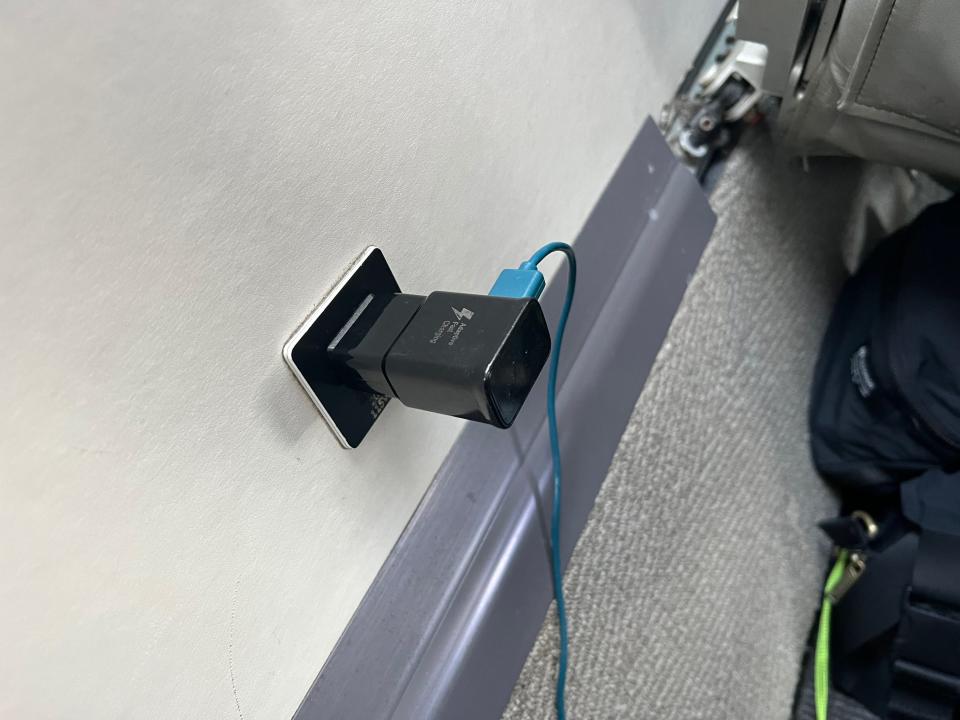 The author's cord plugged into the outlet on the wall of the fuselage.