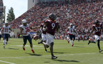 Virginia Tech wide receiver Tayvion Robinson (9) runs past Richmond punter Aaron Trusler (36) left, for a 60 yard kick return touchdown in the first half of the Richmond Virginia Tech NCAA college football game in Blacksburg, Va., Saturday, Sept. 25 2021. (Matt Gentry/The Roanoke Times via AP)