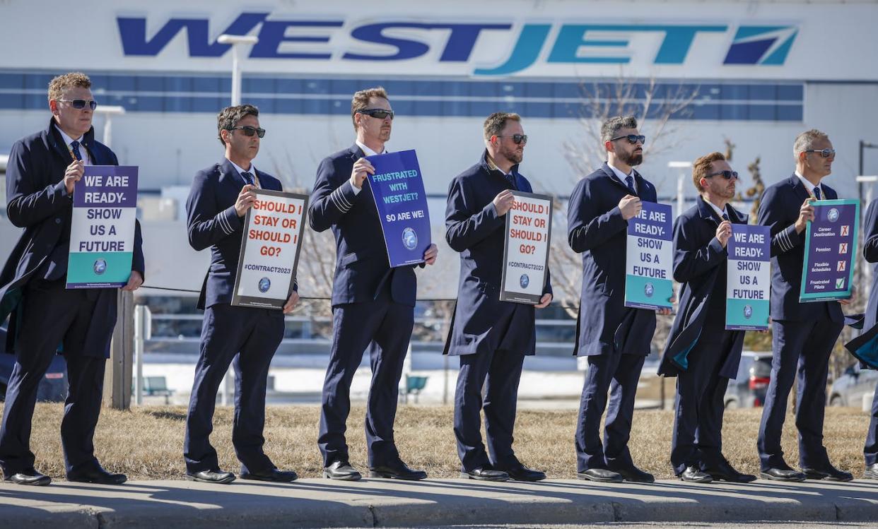 Members of the Air Line Pilots Association demonstrate amid contract negotiations outside the WestJet headquarters in Calgary on March 31, 2023. THE CANADIAN PRESS/Jeff McIntosh