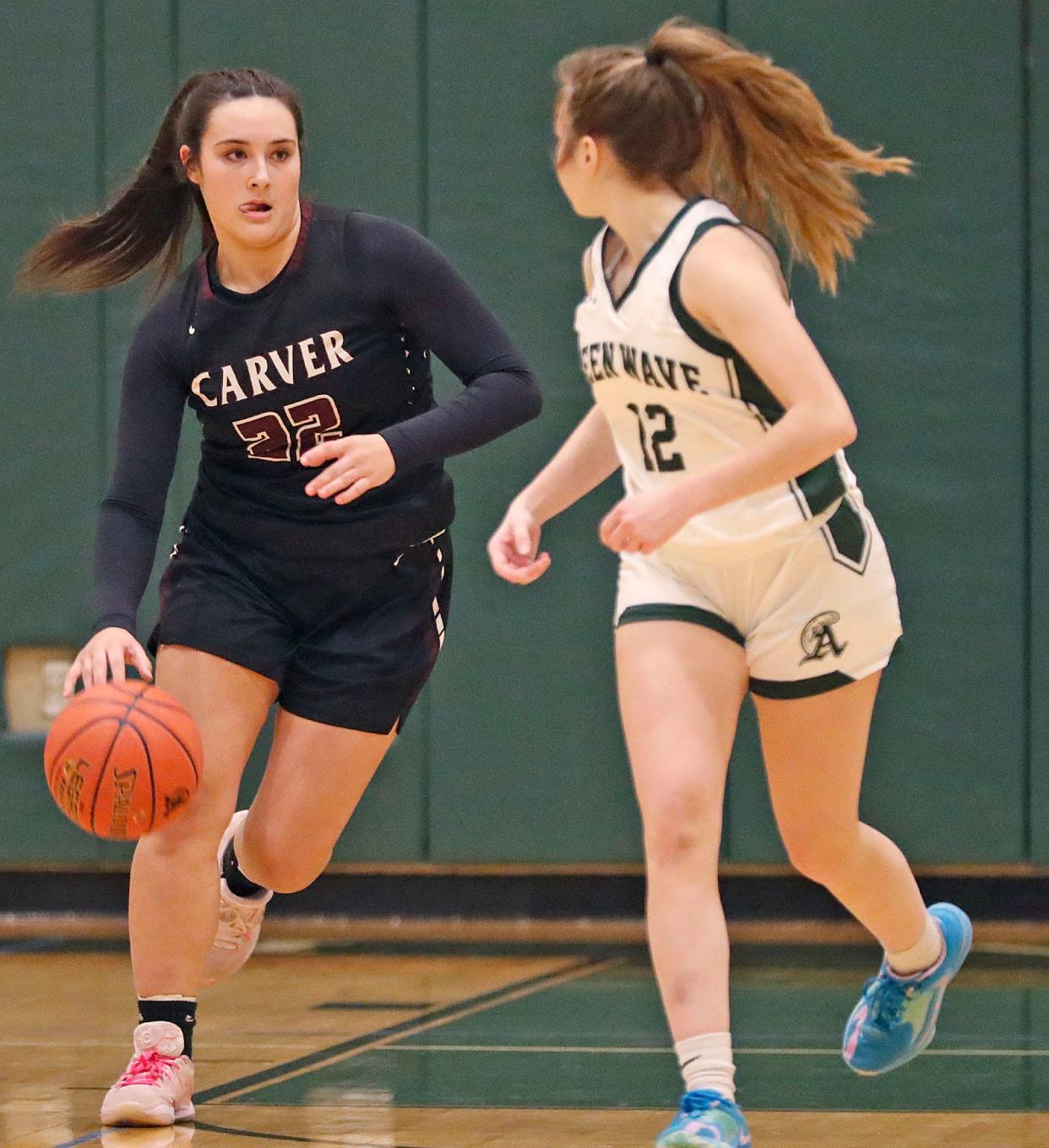 Carver captain Julia Grimes get the ball moving up court while being guarded by Ava Williamson of Abington. 

The Abington Green Wave hosted the Carver Crusaders in girls basketball on Friday Dec. 22, 2023