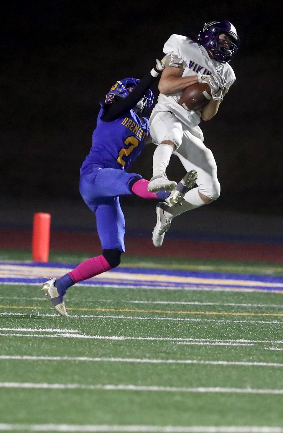 North Kitsap's Logan Sloman intercepts a pass intended for Bremerton's Trenton Bulmer (2) at Bremerton Memorial Stadium on Friday, Oct. 14, 2022.