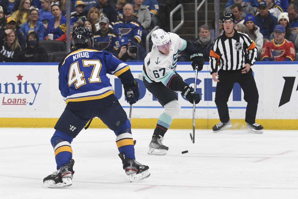 Seattle Kraken's Morgan Geekie (67) shoots a goal against St. Louis Blues' Torey Krug (47) during the first period of an NHL hockey game on Tuesday, Feb. 28, 2023, in St. Louis. (AP Photo/Michael Thomas)