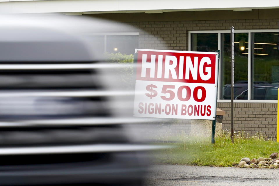 FILE—In this file photo from May 5, 2021, a vehicle speeds by a hiring sign offering a $500 bonus outside a McDonalds restaurant, in Cranberry Township, Butler County, Pa. Pennsylvania will resume work search requirements in July for hundreds of thousands of people receiving unemployment compensation, a top Wolf administration official said Monday, May 24, 2021. (AP Photo/Keith Srakocic, File)