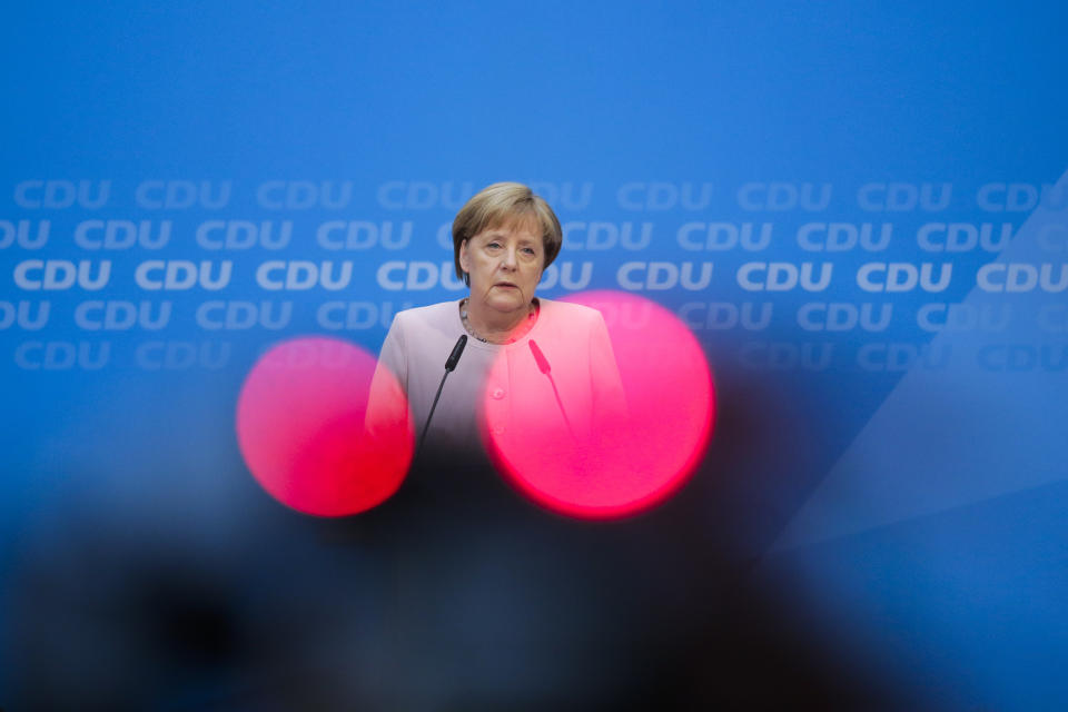 In this picture taken with red television camera control lights in the foreground, German Chancellor Angela Merkel speaks to media prior to a special closed meeting of her Christian Democratic Union at the party's headquarters in Berlin, Germany, Sunday, June 2, 2019. (AP Photo/Markus Schreiber)