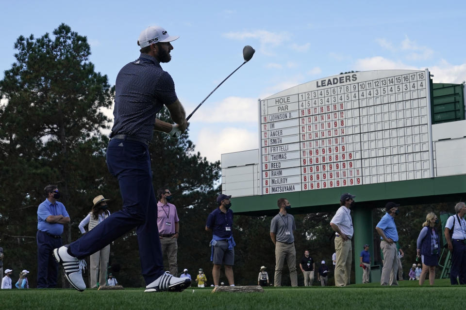 Dustin Johnson follows his tee shot on the eighth hole during the final round of the Masters golf tournament Sunday, Nov. 15, 2020, in Augusta, Ga. (AP Photo/David J. Phillip)