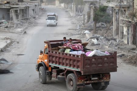 People that fled Islamic State contolled areas travel on the back of a vehicle in al-Rai town, northern Aleppo countryside, Syria October 4, 2016. REUTERS/Khalil Ashawi