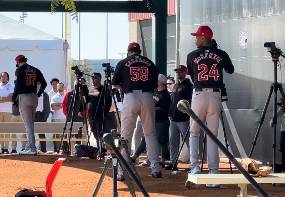 Guardians pitchers Triston McKenzie, Carlos Carrasco and Shane Bieber throw a bullpen session as the team's spring training facility in Goodyear, Ariz.
