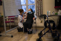 FILE - In this Thursday, Jan. 7, 2021 file photo, a nurse administers the Pfizer/Biontech COVID-19 vaccine to a nun at the CHC Landenne care home in Landenne-sur-Meuse, Belgium. Vaccination programs in the 27 nation-bloc have gotten off to a slow start and some EU members have been quick to blame the EU's executive arm for a perceived failure of delivering the right amount of doses. (AP Photo/Francisco Seco, File)