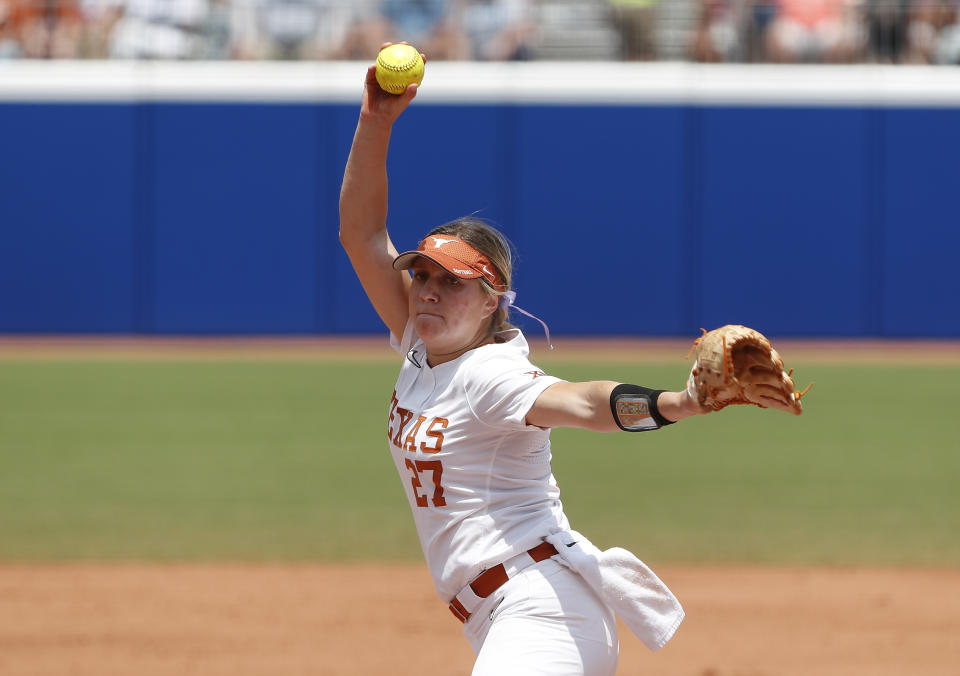 Texas starting pitcher Hailey Dolcini (27) pitches in the first inning of an NCAA Women's College World Series softball game against Oklahoma on Saturday, June 4, 2022, in Oklahoma City. (AP Photo/Alonzo Adams)