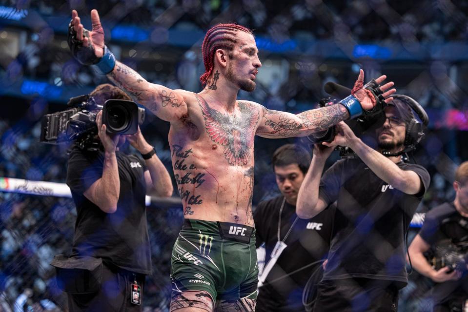 Sean O'Malley (blue gloves) defeats Petr Yan (red gloveS) during UFC 280 at Etihad Arena.