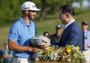 Mar 26, 2017; Austin, TX, USA; Dustin Johnson of the United States receives The Walter Hagen Trophy from Michael Dell, CEO and founder of Dell Technologies, after beating Jon Rahm of Spain in the final round of the World Golf Classic - Dell Match Play golf tournament at Austin Country Club. Mandatory Credit: Erich Schlegel-USA TODAY Sports