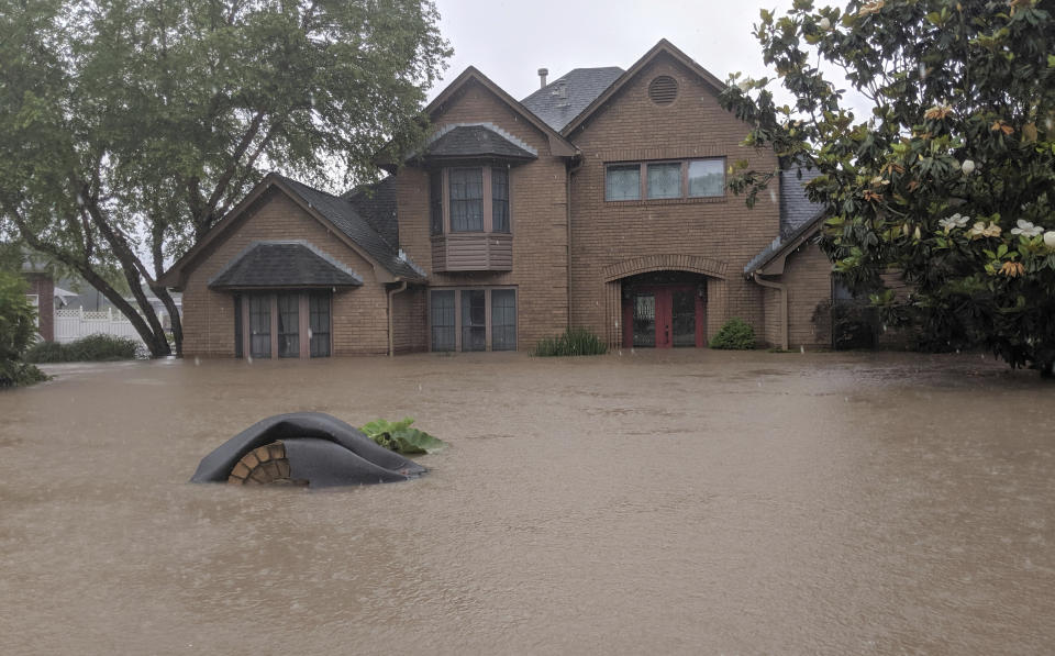 Flood waters surround homes in Fort Smith, Ark., Wednesday, May 29, 2019. Flood waters from the Arkansas River continue to rise. (AP Photo/Hannah Grabenstein)