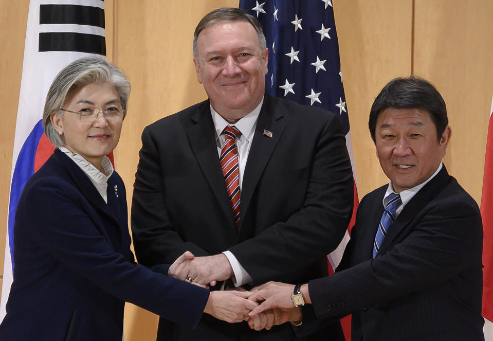 U.S. Secretary of State Mike Pompeo, center, shakes hands with Japan's Foreign Minister Toshimitsu Motegi, right, and South Korea's Foreign Minister Kang Kyung-wha during a trilateral meeting during the 56th Munich Security Conference (MSC) in Munich, southern Germany, Saturday, Feb. 15, 2020. (Andrew Caballero-Reynolds/Pool Photo via AP)