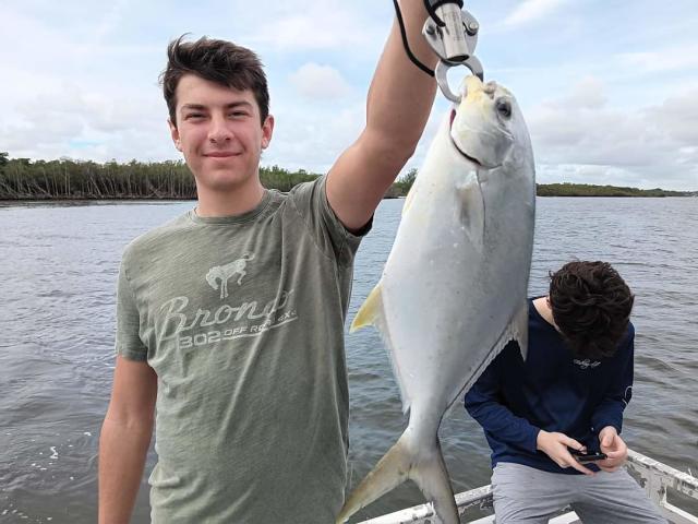 Mark West holds a fishing net as he and Dan Ladd try to capture a