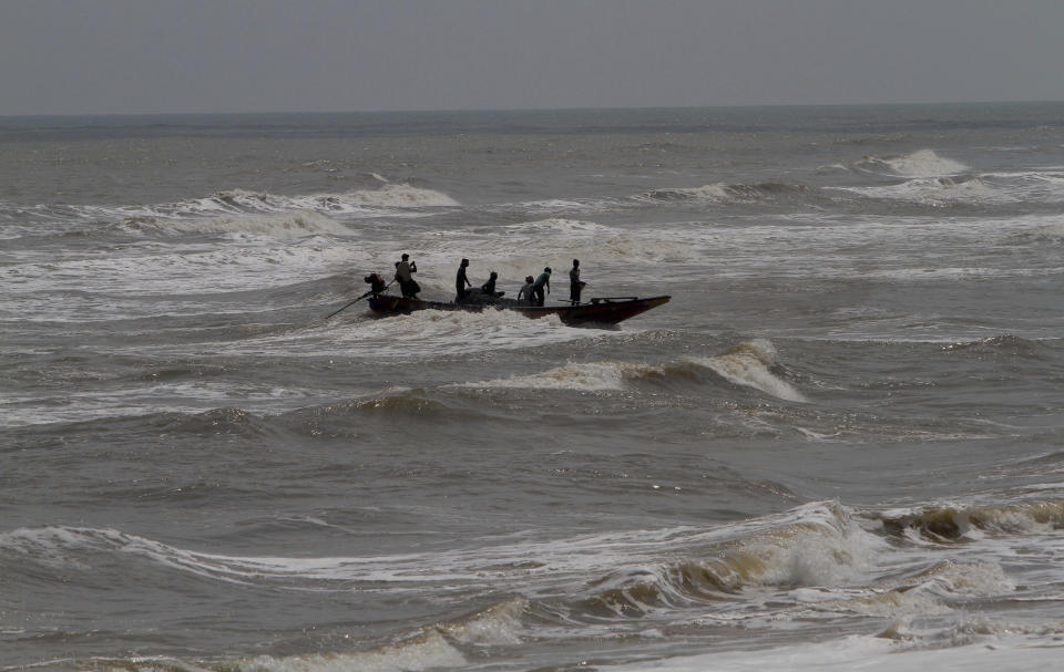 In this Wednesday, May 1, 2019 photo, Indian fishermen attempt to bring their boat ashore amid strong winds at Chandrabhaga beach in Puri district of eastern Odisha state, India. Hundreds of thousands of people were evacuated along India's eastern coast on Thursday as authorities braced for a cyclone moving through the Bay of Bengal that was forecast to bring extremely severe wind and rain. (AP Photo)