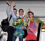 (L-R) Freed hikers Shane Bauer, Josh Fattal, and Sarah Shourd wave from the door of an airplane before leaving for the US on September 24, at Muscat airport in Oman. The three were taken into custody by Iranian border guards on July 21, 2009, for allegedly crossing into Iran while hiking near the Iranian border in Iraqi Kurdistan. Sarah Shourd was released 14 months later on ‘humanitarian grounds’ while Fattal and Bauer were released on September 21, under a $1 million bail deal. (AP Photo/Sultan al-Hasani)