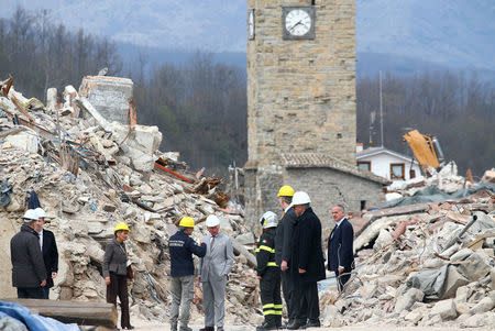 Britain's Prince Charles talks with a member of Italy's Civil Protection agency during his visit to the town of Amatrice, which was levelled after an earthquake last year, in central Italy April 2, 2017. REUTERS/Alessandro Bianchi