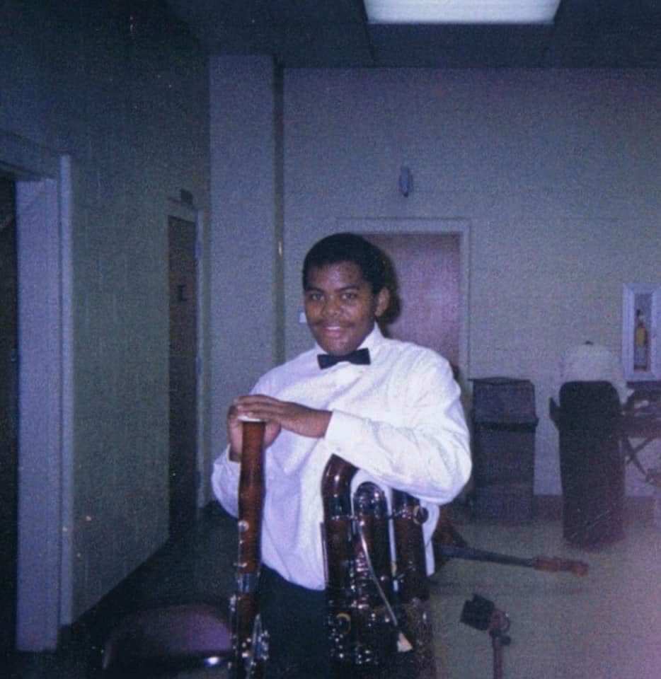 A young Anthony Parnther with the bassoon that his mother bought for him.