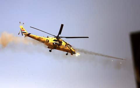  An Iraqi Army, Russian built Mi-28 attack helicopter fires towards the position of the Islamic State group - Credit: EPA/STR