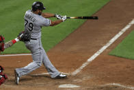 Chicago White Sox's Jose Abreu hits a solo home run in the eighth inning during a baseball game against the Cincinnati Reds in Cincinnati, Saturday, Sept. 19, 2020. (AP Photo/Aaron Doster)