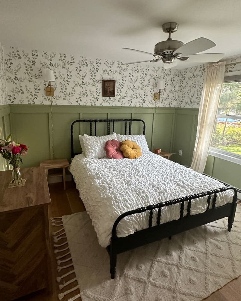 Wainscoting around newly renovated bedroom with floral wallpaper.